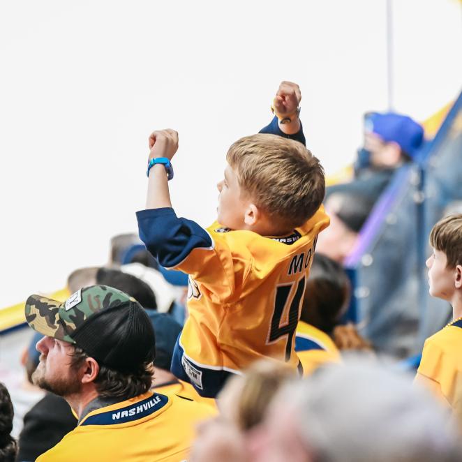Kid cheering for Nashville Predators