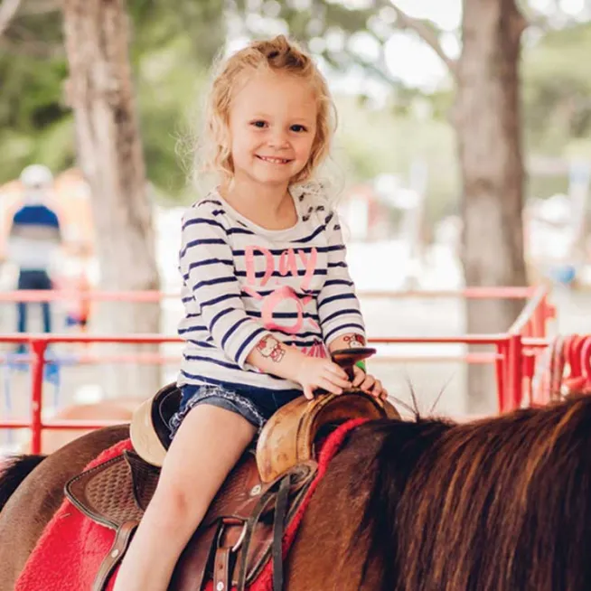 Girl riding horse at Lucky Ladd Farms